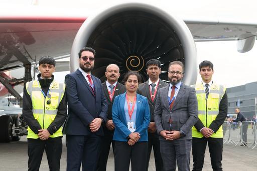 Pyrex officers airside beside an aircraft engine